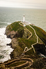 South Stack Lighthouse, North Wales, UK white light house at the end of a long winding path down to sea
