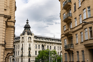 View toward ornate dome-topped corner building on Konečného náměstí from Žižkova Street, Brno – historic architecture and city traffic