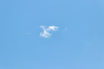 one lonely white cloud on a blue background