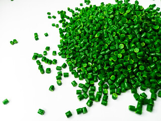 Green polymer granules, blue masterbatch granules, cold cutting material type, isolated on white...