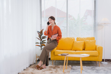 Woman Talking on Phone in Bright Living Room