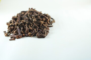 Stack of dried cloves isolated on white background. Aromatic spice used in cooking, baking, and...