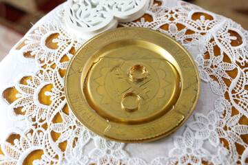 Wedding gold rings on a tray. Wedding ceremony.