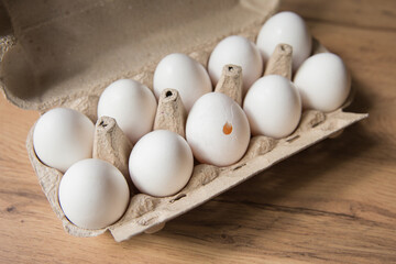 Carton of Eggs with Broken Egg