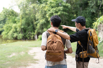 Father and Son Exploring Nature. Two men enjoying a scenic view while hiking.