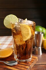 Refreshing Cuba libre cocktail and ingredients on wooden table