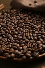 Aromatic coffee beans on table, closeup view