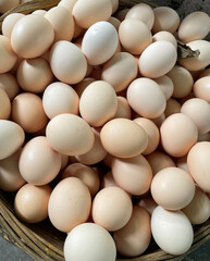 Closeup of fresh eggs in wicker basket - rural farmer's market