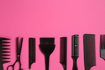 Different hairdresser's tools on pink background, flat lay. Space for text