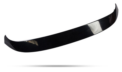 Black plastic spoiler for installation on the trunk lid of a car for tuning on a white isolated background in a photo studio at auto-analysis. Sporty design in the workshop