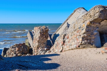 War-Era Remains Eroded by Time and Waves. Crumbling Bunker on a Seaside Cliff.