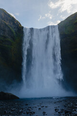 Majestic Skogafoss waterfall cascading down rocky cliffs in Icelands stunning landscape