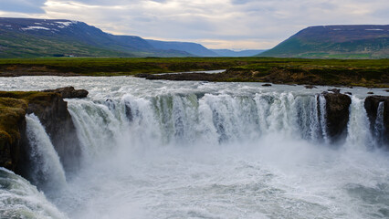 Majestic waterfalls cascading through vibrant landscapes in Icelands untouched nature