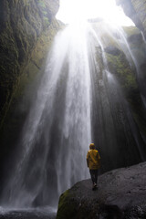 Gljufrabui waterfall cascades within Icelands hidden canyon, inviting exploration and adventure