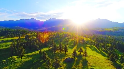Obraz premium Sunrise aerial view of mountain meadow, forest, and peaks