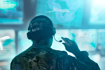 Military drone operator in the army call center with many blue monitors