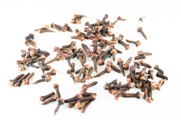 Scattered dried cloves on a clean white background. Ideal for food, spice, herbal medicine, and...