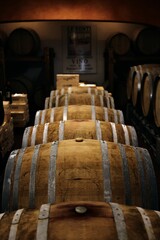 Dimly lit wine cellar with wooden barrels.