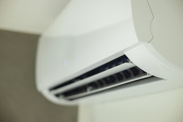 Detailed close-up of adjustable air conditioner louvers, part of a sleek indoor climate control...