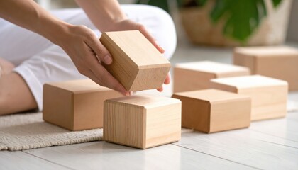 Woman Arranging Light Brown Wooden Yoga Blocks