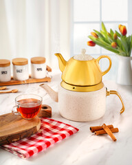 Matching Teapot and Kettle Set in Cozy Kitchen Scene with Tea Cup