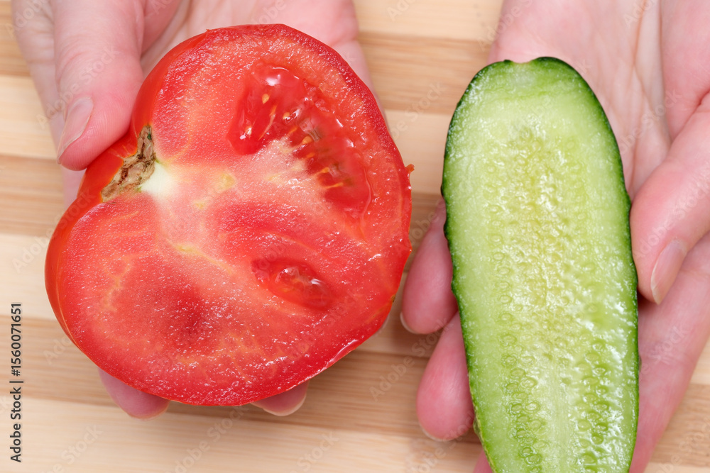 Poster freshly sliced tomato and cucumber on a wooden countertop display