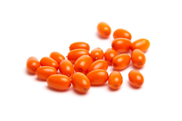 A collection of bright orange sea buckthorn berries with a smooth, glossy texture, scattered on a...