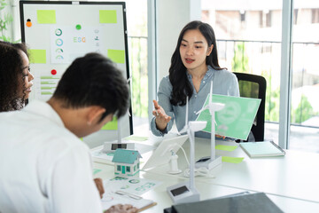 Obraz premium ESG and Sustainability Discussion. Team collaborating on environmental strategies in a modern workspace.
