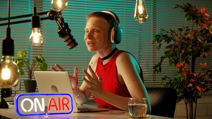 Young Woman Hosting Live Radio Show in Studio with Microphone