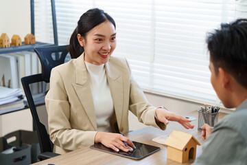 Real Estate Agent Consulting with Client in Office