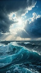 Fototapeta premium Dramatic ocean scene with large waves under a cloudy sky and sun rays breaking through