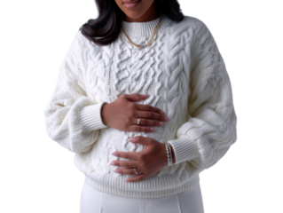 Gentle Embrace: A radiant expectant mother in a delicate cable-knit sweater, tenderly cradling her burgeoning belly, her eyes closed in a moment of peaceful reflection.