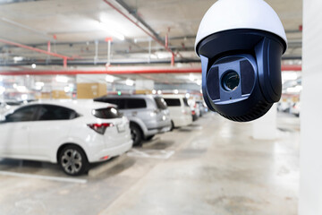 CCTV surveillance camera monitoring indoor parking garage with multiple cars parked in secure...