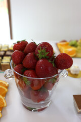 Fruit and cakes on a festive buffet table.
