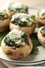 Tasty stuffed mushrooms served on table, closeup