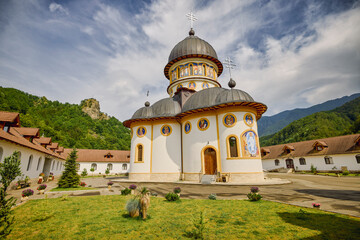 image from the outside of a church in Romania with paintings specific to the area and the Orthodox...