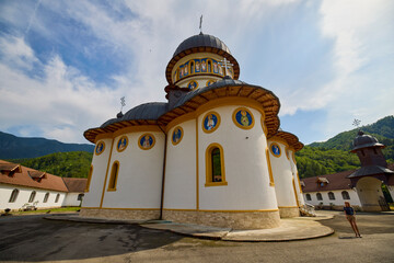 image from the outside of a church in Romania with paintings specific to the area and the Orthodox...