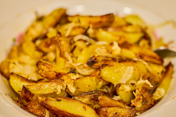potatoes cut and cooked in the oven with onion and cheese