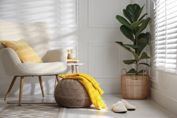 Stylish knitted pouf with sweater at home