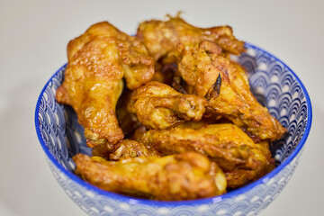 a bowl of cooked chicken wings with barbecue sauce