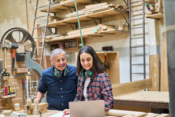 Young and senior workers collaborating in a busy lumberyard