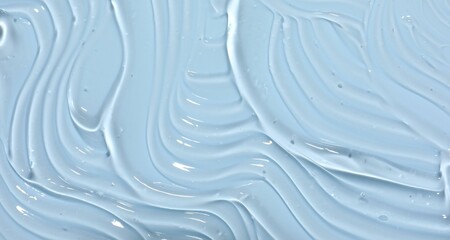 Sample of cosmetic product on light blue background, closeup