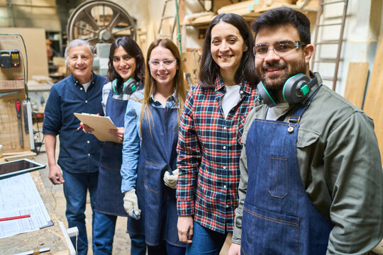 Team of skilled workers collaborating in a bustling lumberyard