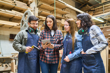 Team of workers collaborating in a lumberyard workshop