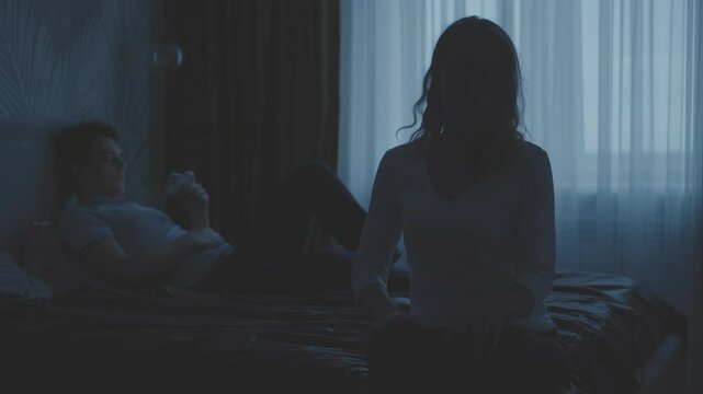 Silhouette couple in bed family problem. Sad upset lonely woman wife offended get mad at man husband addict with mobile phone browsing social media addicted internet game web apps, guy ignoring girl - Powered by Adobe