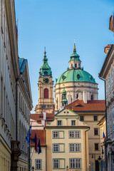 A view towards ornate buildings down a side street in central Prague in springtime