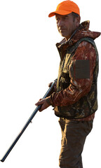 Mature man hunter with gun while walking on field.