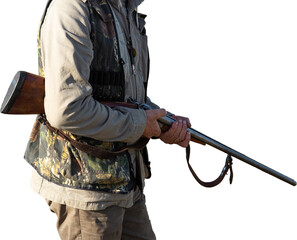 Mature man hunter with gun while walking on field with your dogs