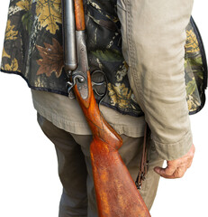 Mature man hunter with gun while walking on field.