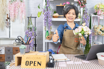 Asian senior woman, florist, small business, owner, entrepreneur manage store accounting with...